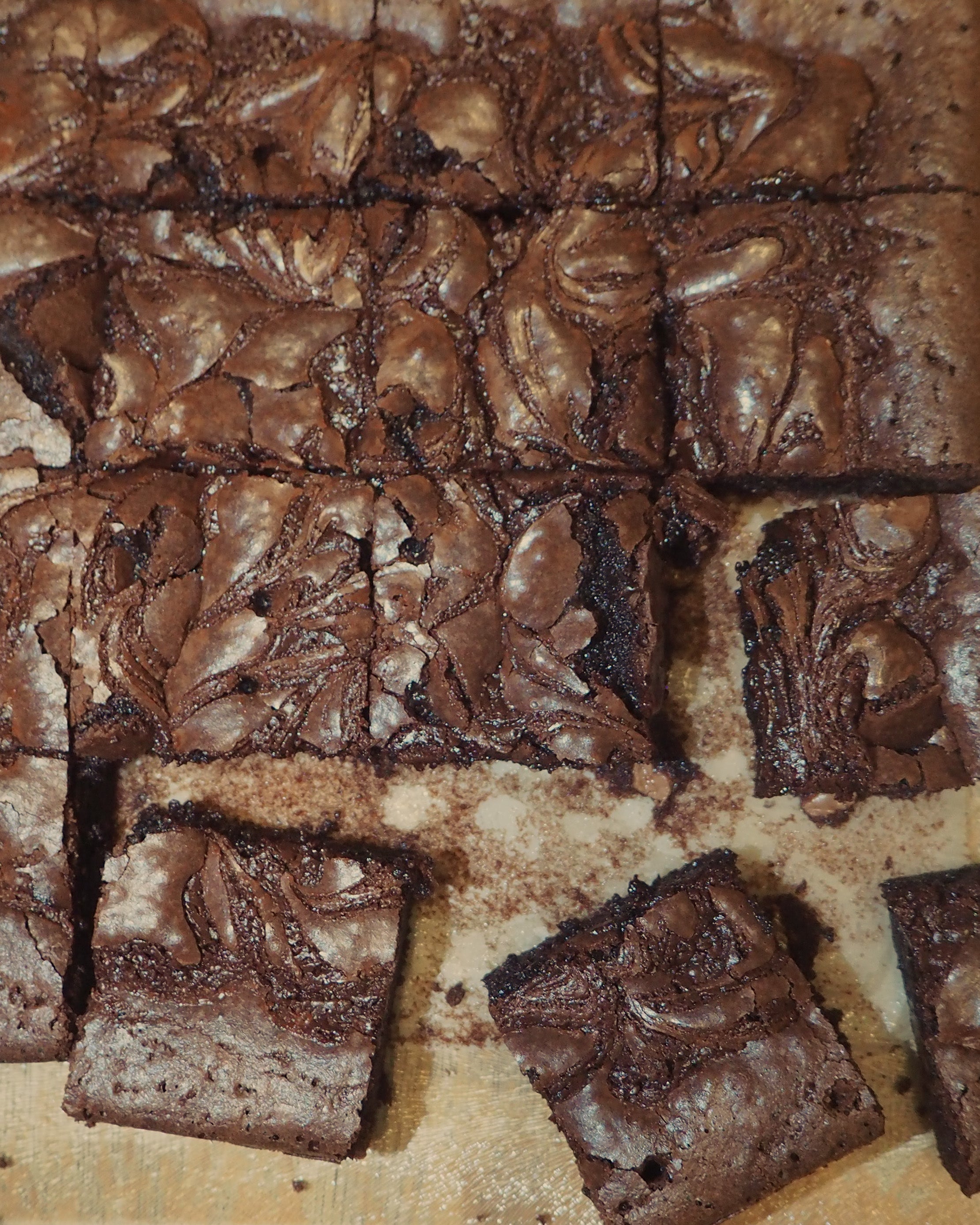 Brownies cut into squares on a wooden surface